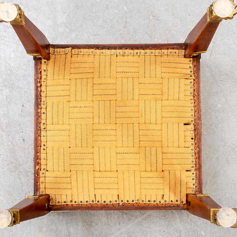 An Empire style mahogany stool around 1900.