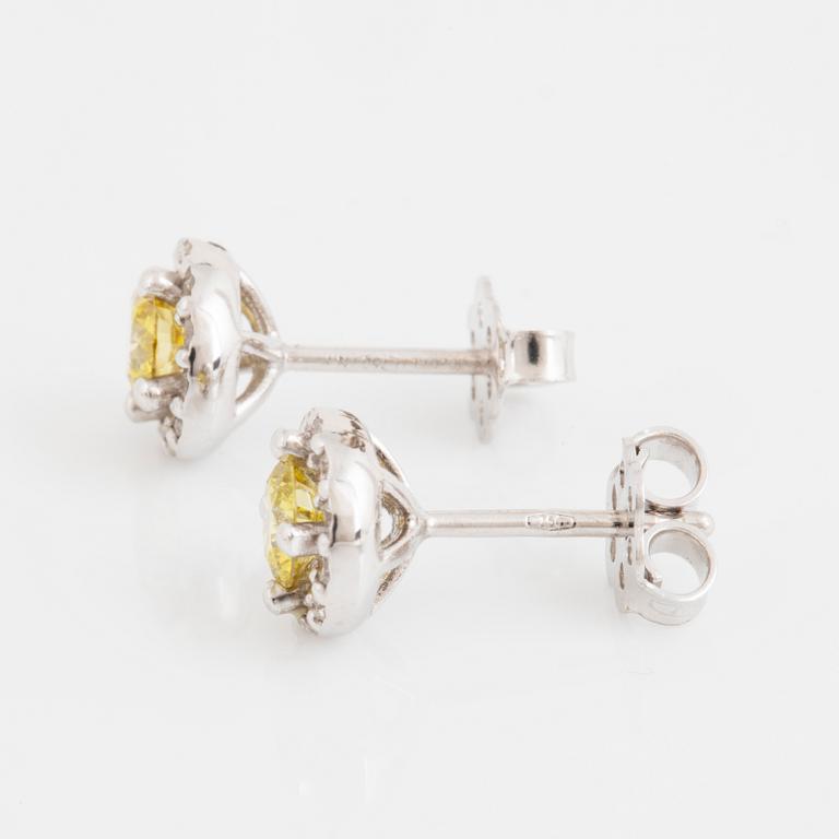 A pair of 18K gold earrings set with color treated yellow diamonds.