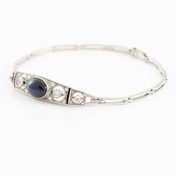 A bracelet in platinum set with old-cut diamonds and a blue stone.