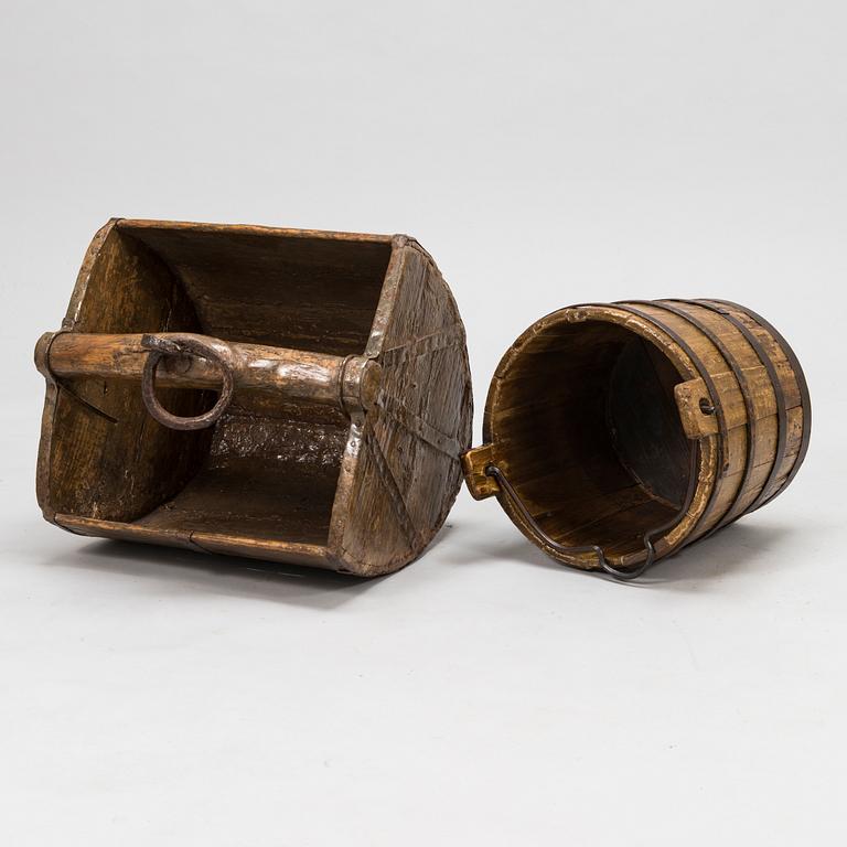 A wooden scoop and bucket and three glass spheres, 18th and 19th Century.