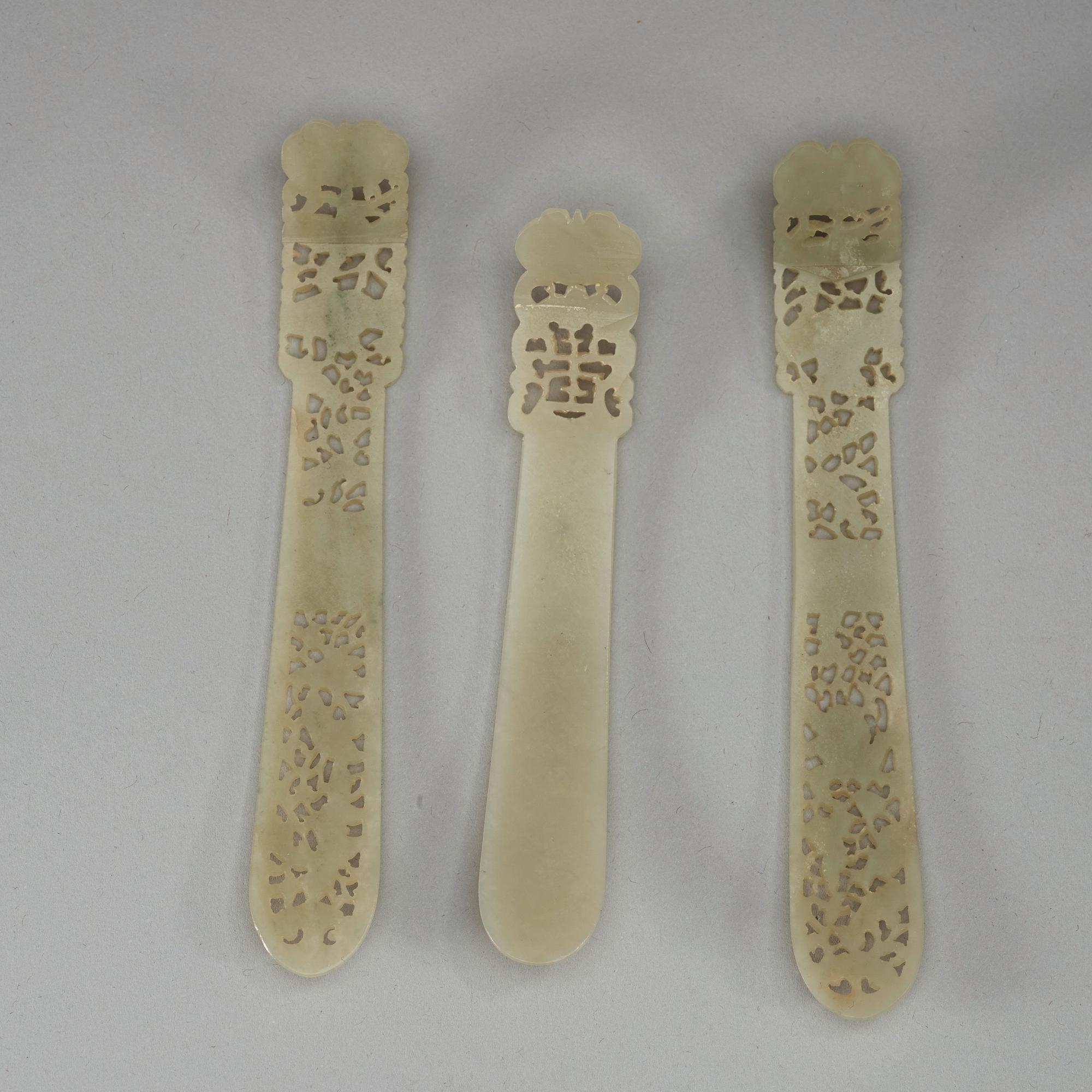 Three pale celadon carved nephrite hair adornments, late Qing dynasty (1644-1912).