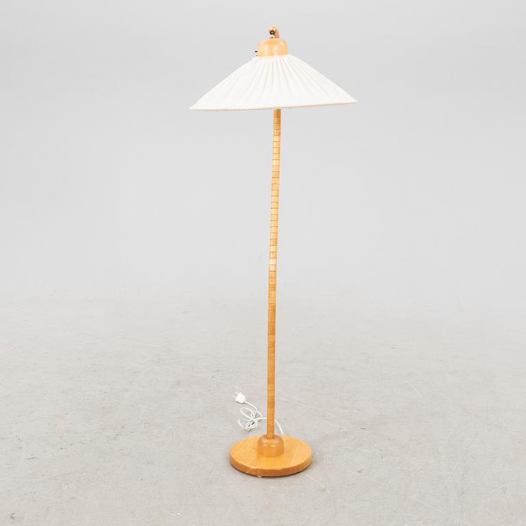 A Markslöjd 21st century wooden floor lamp.