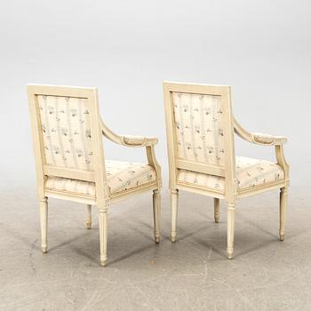 A pair of Gustavian style painted armchairs from around 1900.