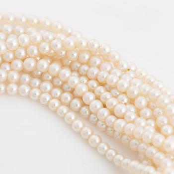 Cultured pearl bracelet, eleven strand, clasp white gold with sapphire and diamonds.