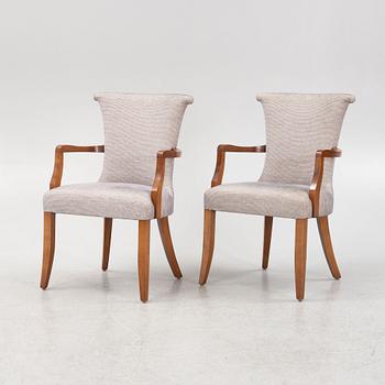 A pair of stained beech armchairs, 20th Century.