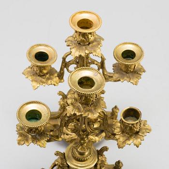 A table CLOCK and a pair of candelabra, second part of 19th century.