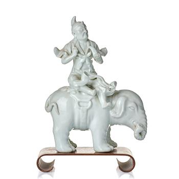 971. A blanc de chine figure of a man on an elephant, late Qing dynasty.