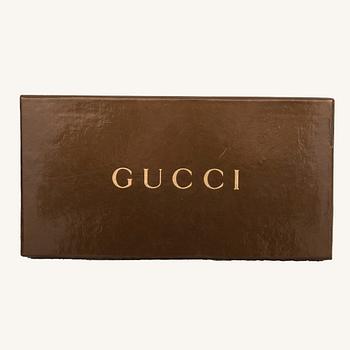 Gucci,.