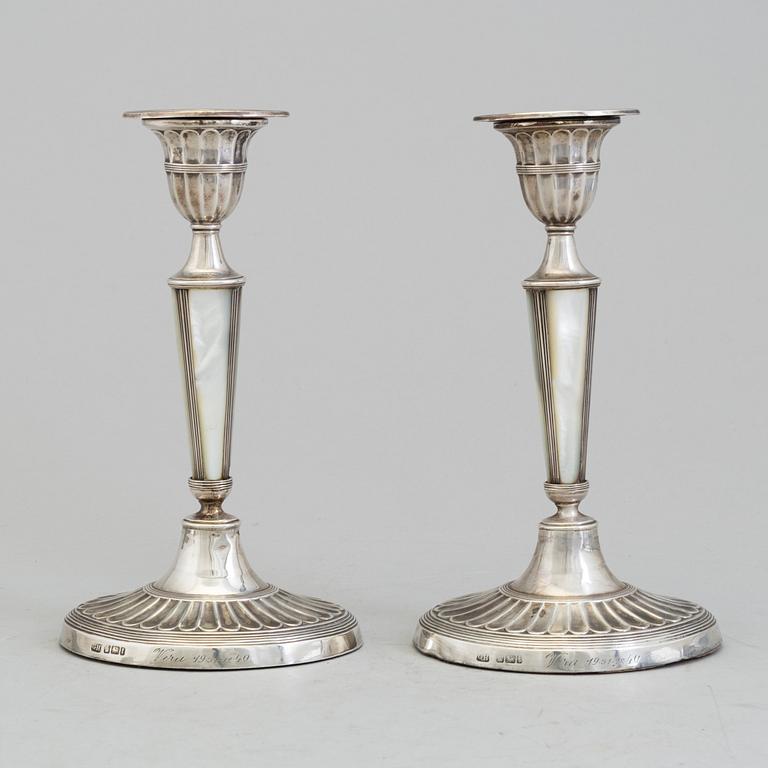 HARRISON BROTHERS & HOWSON, a pair of silver and mother of pearl candlesticks from Sheffield, England, 1926.