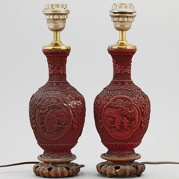 A pair of Chinese red lacquered vases, turned into table lamps, 20th century.