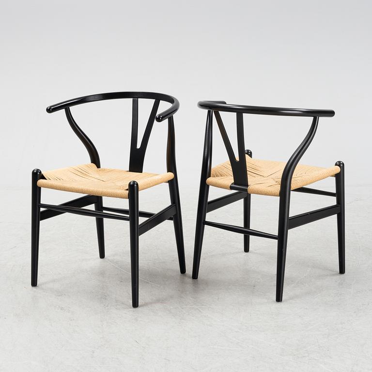 Hans J Wegner, a set of four 'Wishbone chairs' by for Carl Hansen & Son, Denmark.