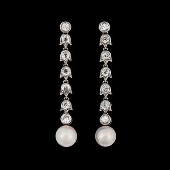 A pair of diamond and natural fresh water pearl earrings.
