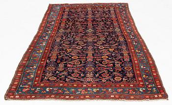 A carpet, semi-antique kurdish, circa 300 x 147 cm.