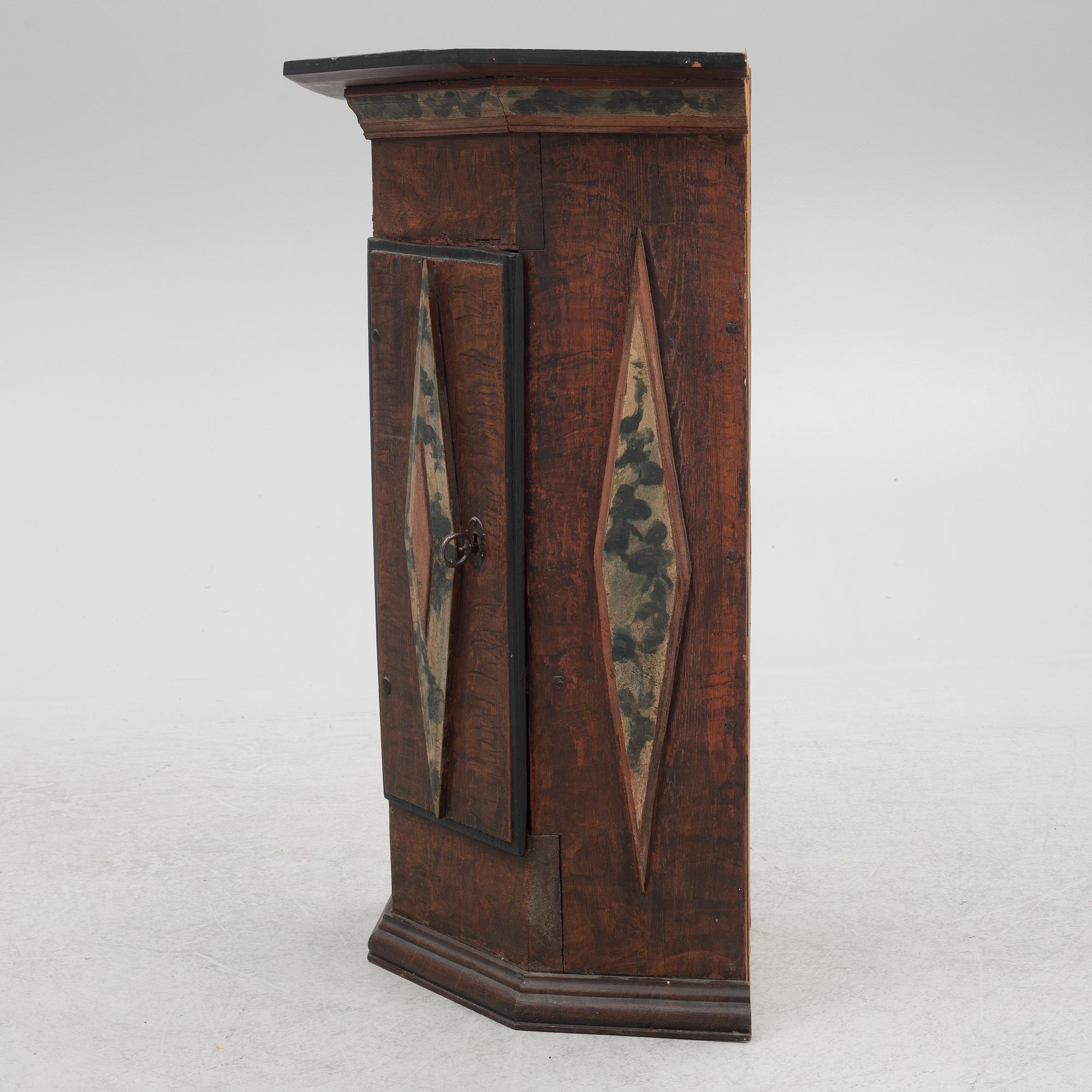 A corner cabinet, 18th Century.