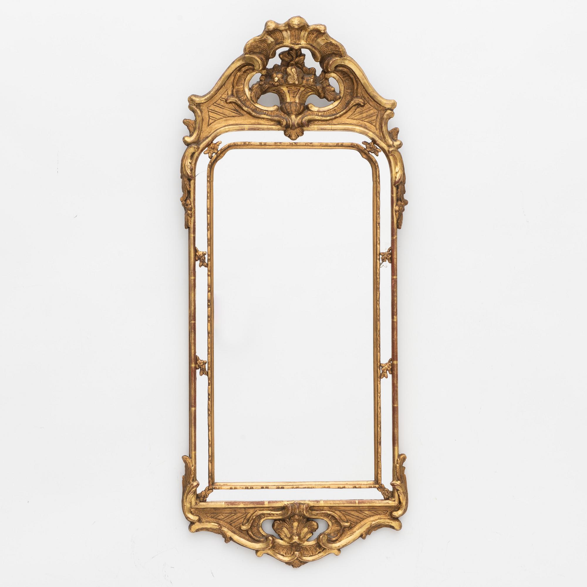 A Rococo style mirror, circa 1900.
