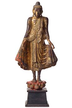 702. A gilt lacquered figure of a standing buddha, Burma, Mandalay period.