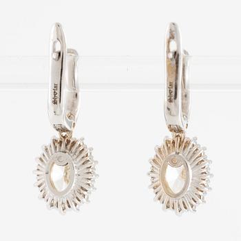 Earrings 18K white gold set with oval-cut diamonds, accompanied by GIA report.