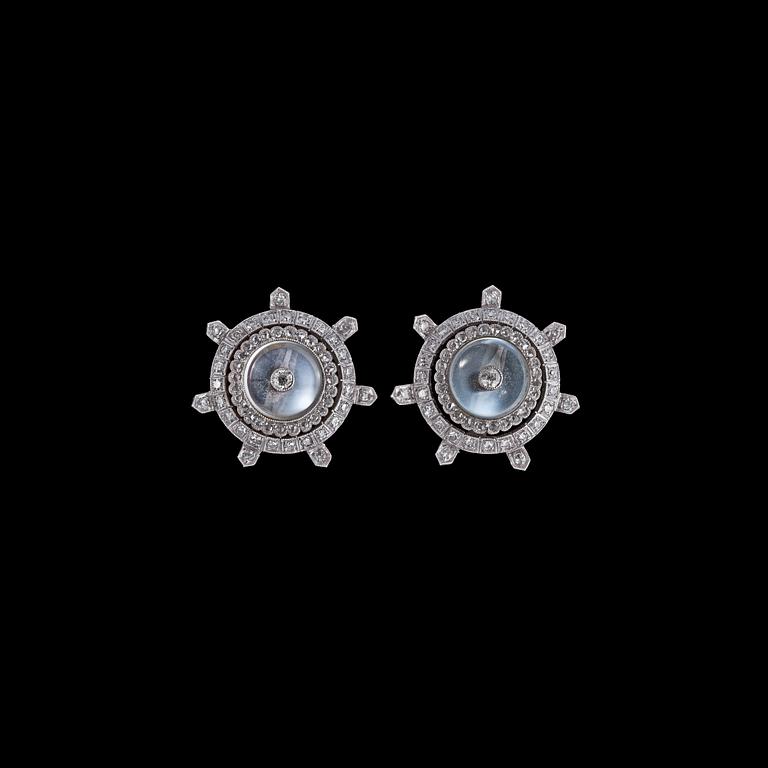 A pair od moon stone and diamond earclips.