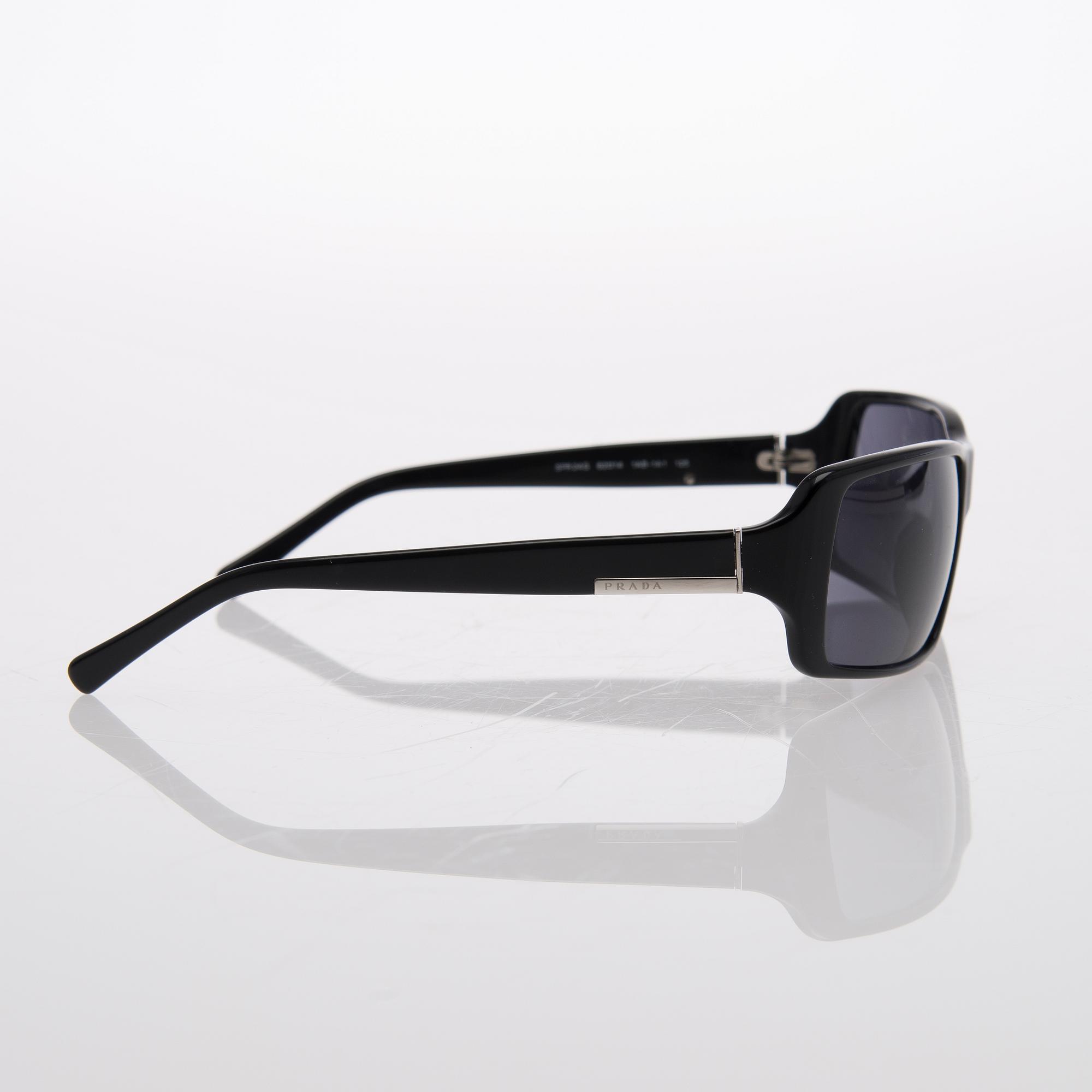 Two Pairs of Sunglasses, Prada and Chanel.