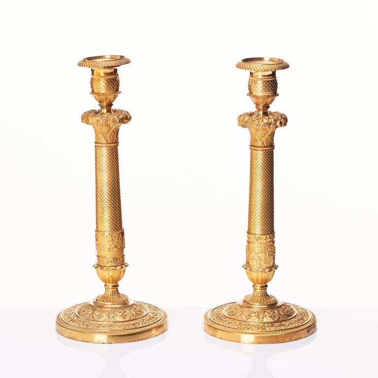 A pair of French gilded Empire candlesticks, early 19th century.