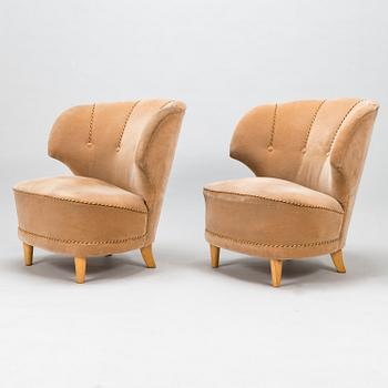 A pair of mid-20th-century armchairs.