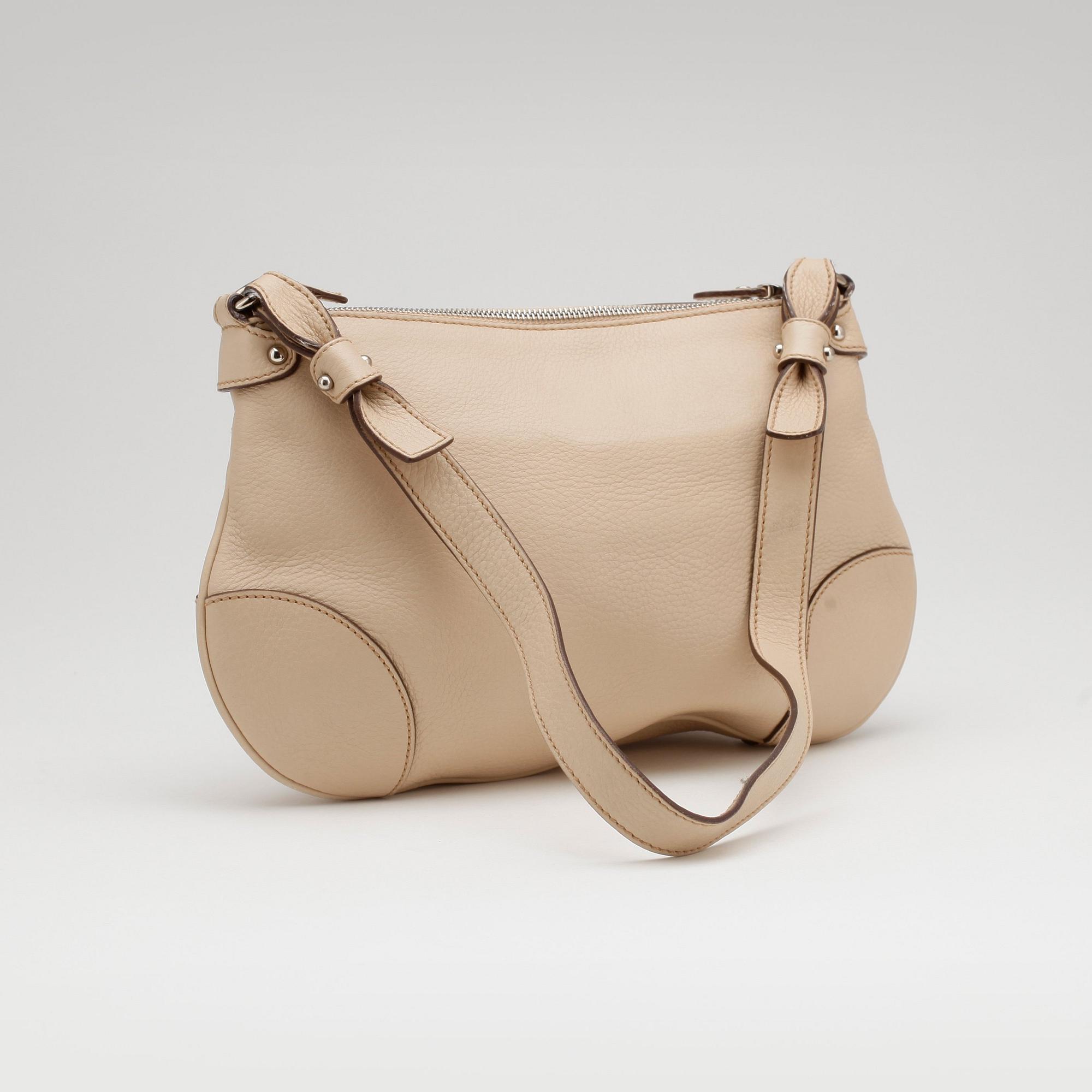 SALVATORE FERRAGAMO, a beige leather shoulder bag and a pair of beige leather loafers.