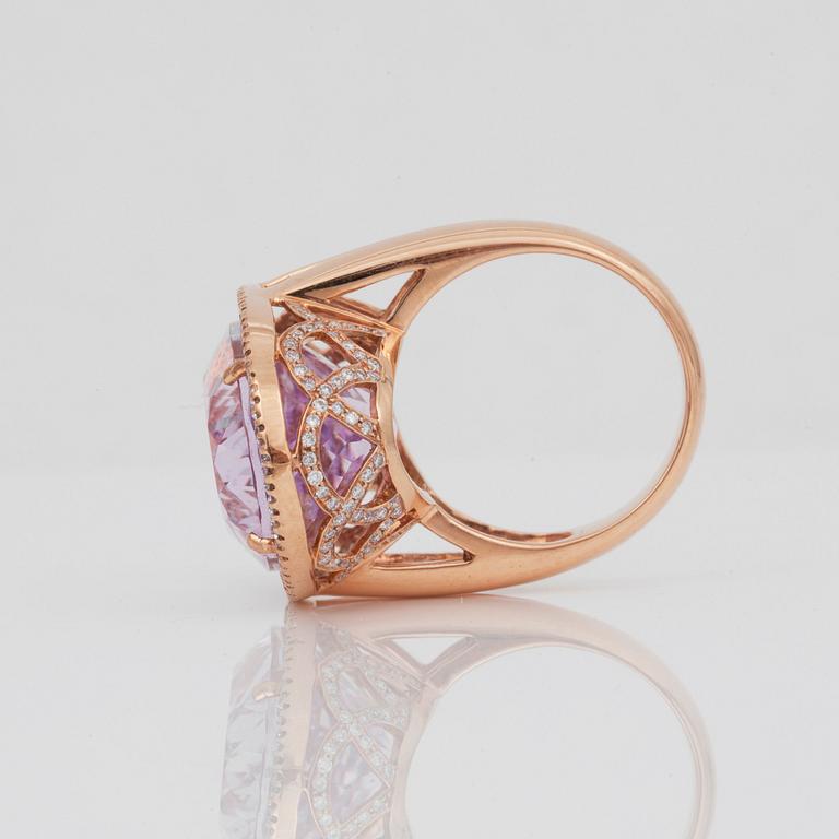 A kunzite, circa 30.00 ct, and diamond, circa 1.10 ct, ring.