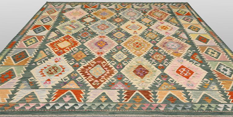 A Kelim carpet, 306 x 257 cm.