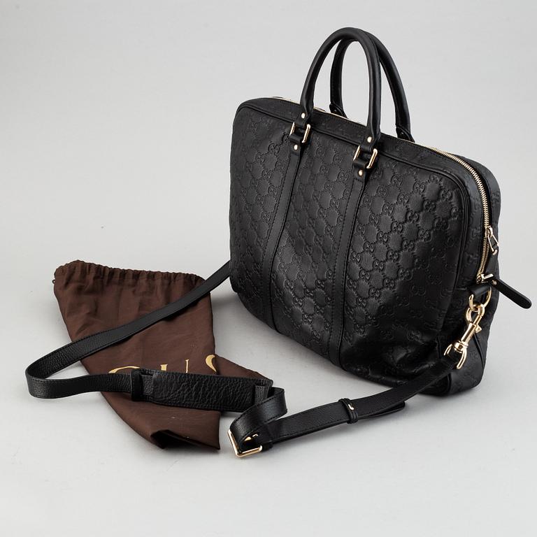 Gucci, a monogram leather bag/laptop-bag.