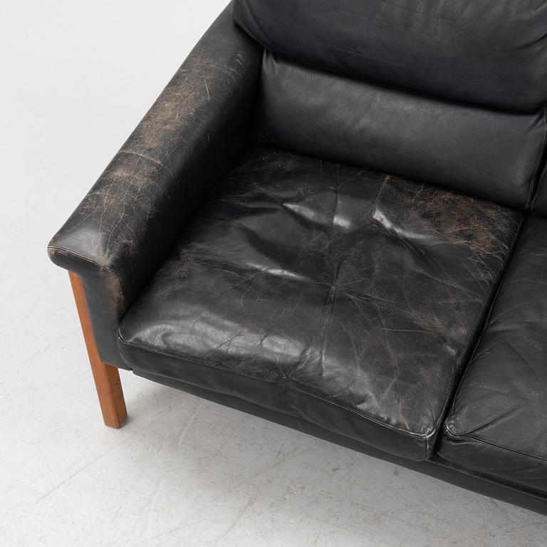 A leather and teak sofa, 1960-70s.