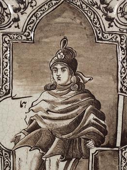 A Qajar moulded figural pottery tile, ca 60 x 44 cm.