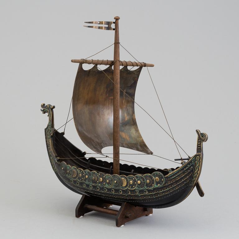 A min 20th century model of a viking ship, brass and copper.