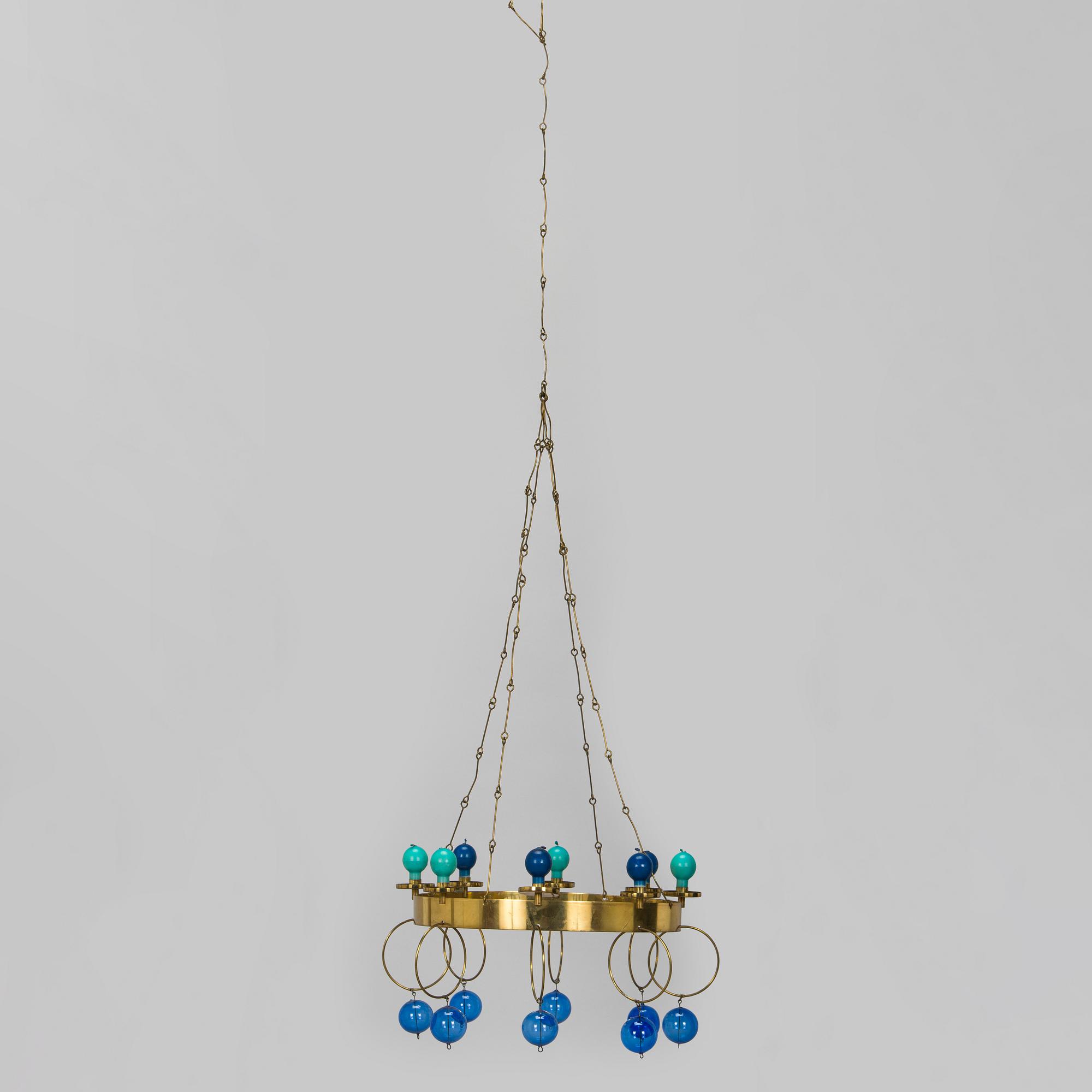 Kaija Aarikka, A 1960s/1970s brass mobile candelabra by Aarikka with candles by Timo Sarpaneva.