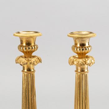 A pare of late empire candelsticks mid 19th century.