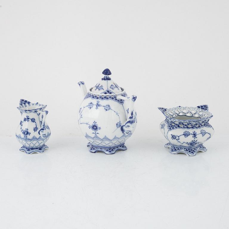 A 'Musselmalet' porcelain teapot, a creamer and a sugarbowl, Royal Copenhagen, Denmark.