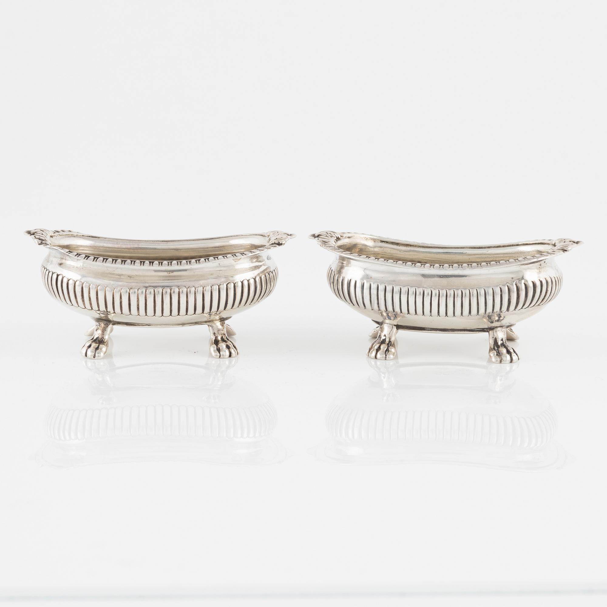 A pair of English Silver Salt Cellars, marks ofJoseph Angell Il 1823 and Samuel Dutton 1826 respectively, London.