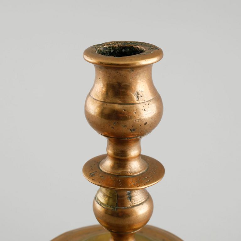 A 18th century baroque candlestick in brass.