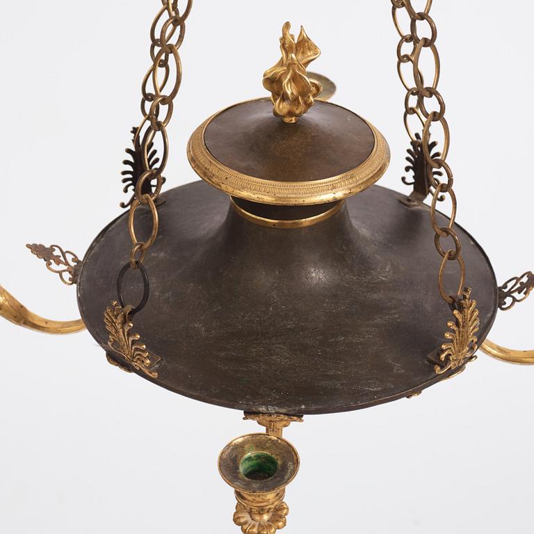 An ormolu and painted bronze four-light Empire chandelier, early 19th century.