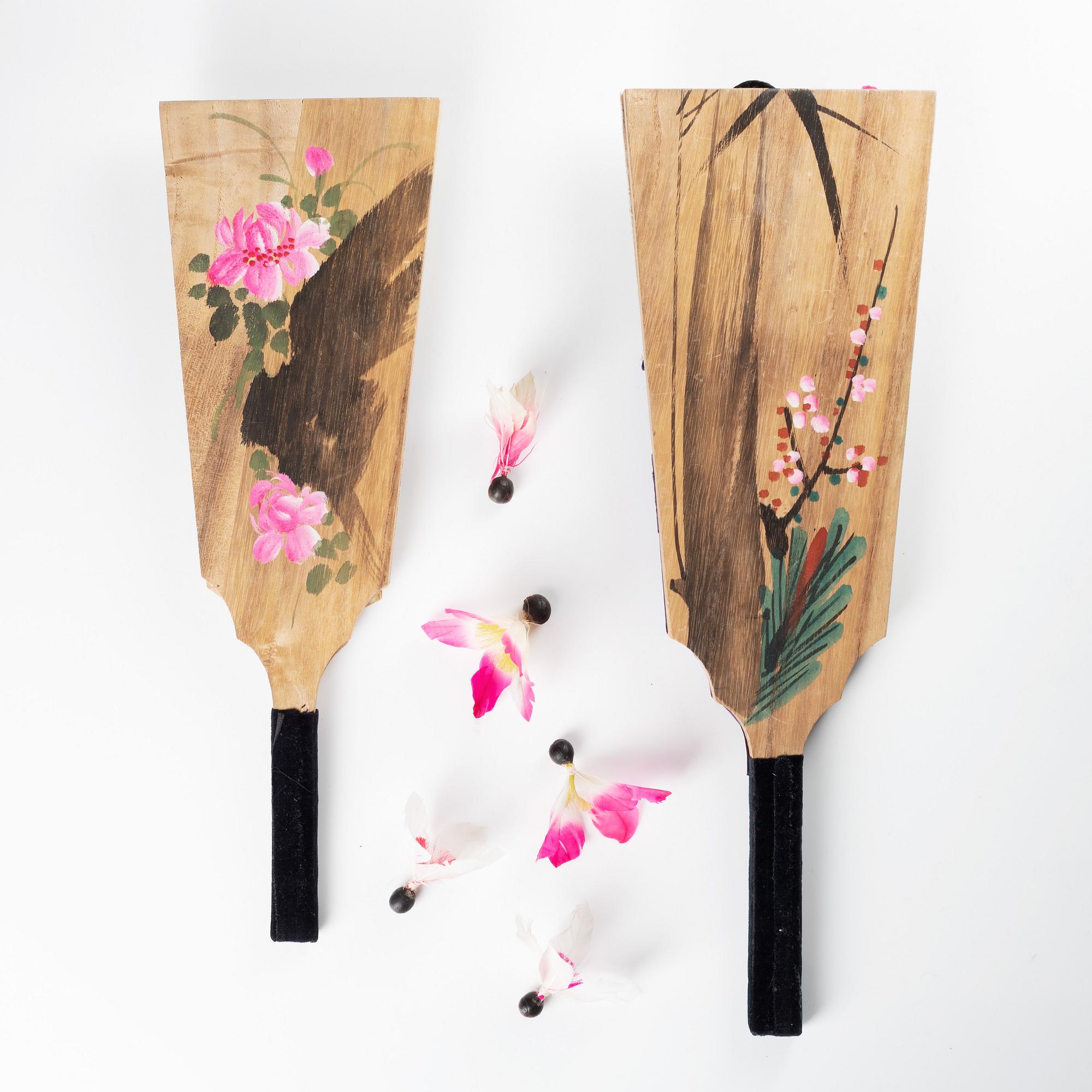 A set of two Japanese hagoita wooden paddles and five shuttlecocks, first part of 20th century.