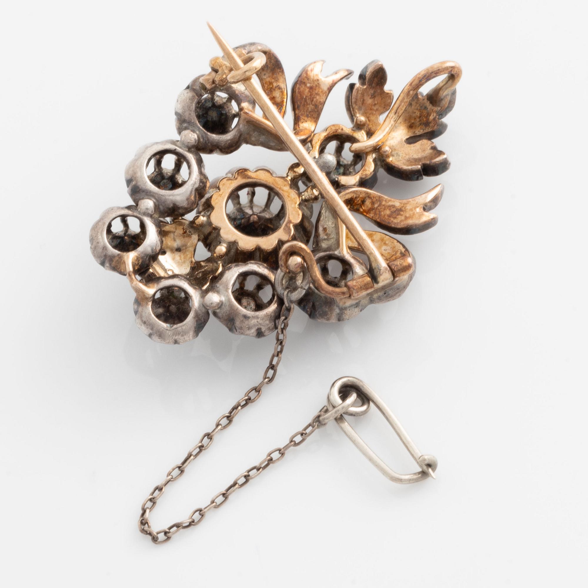 A silver brooch set with rose-cut diamonds.