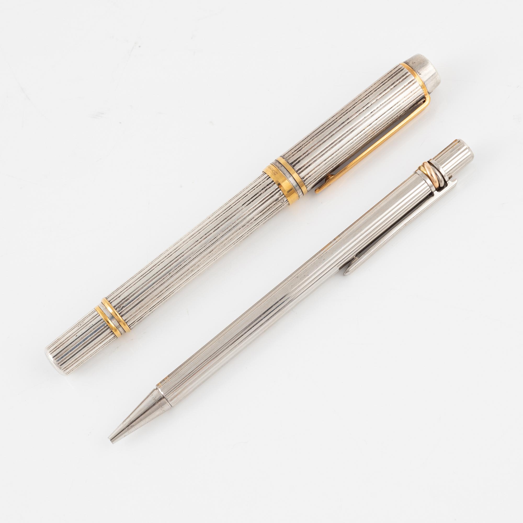 Two pens, Waterman and Cartier.