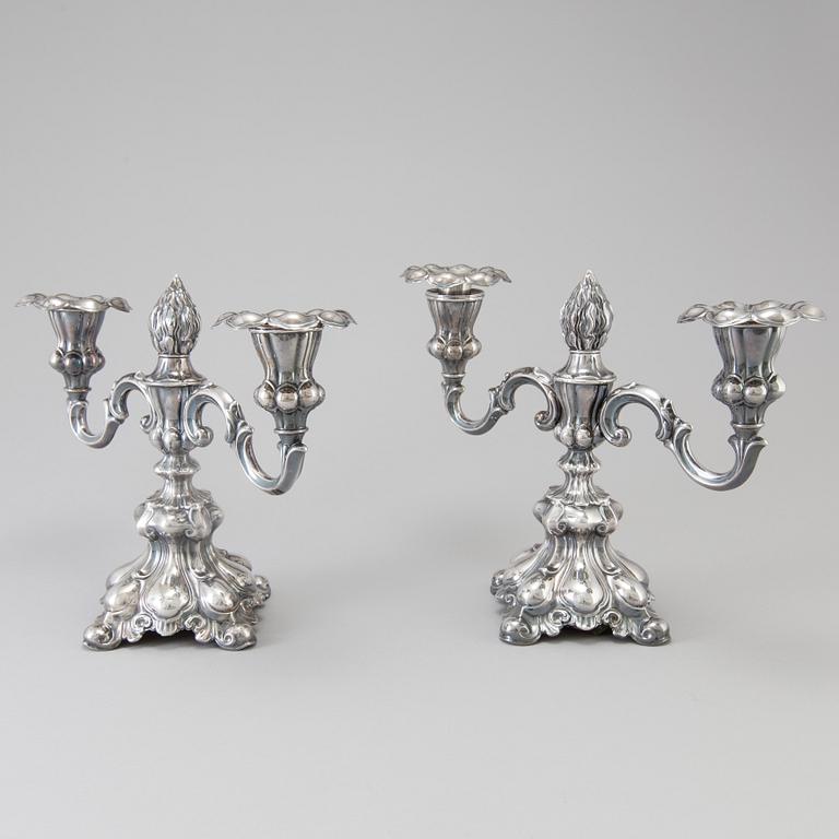 A pair of Swedish Rococo style silver candelabras from C G Hallberg in Stockholm 1955 and 1959.