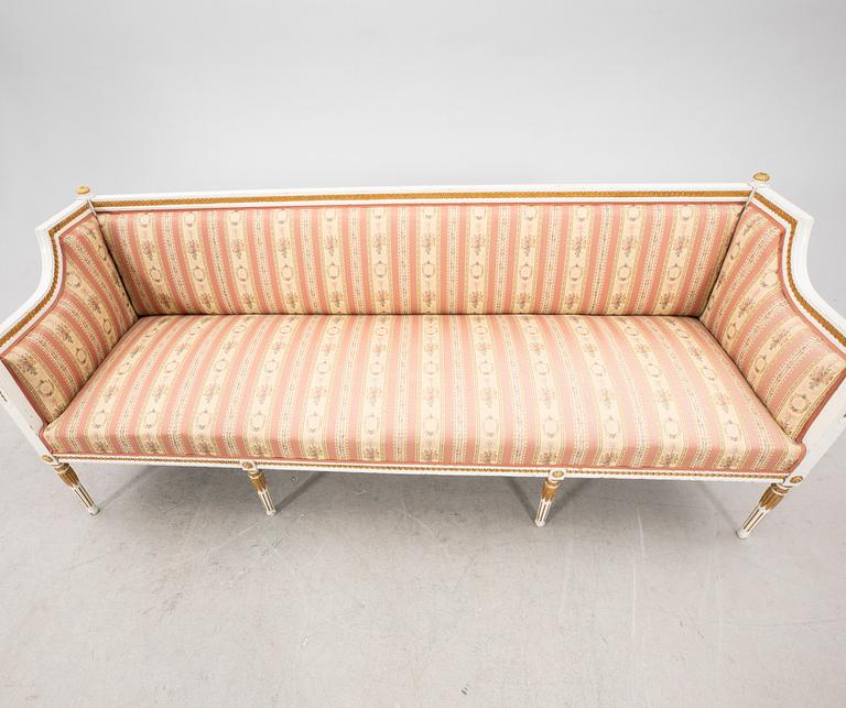 A painted and guilded late gustavian sofa from the 19th century.