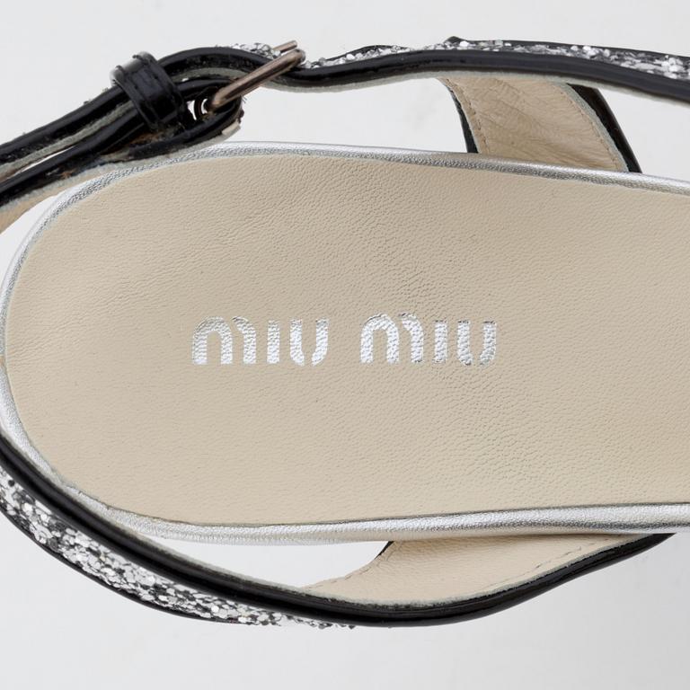 MIU MIU, a pair of glitter embellished leather sandals.