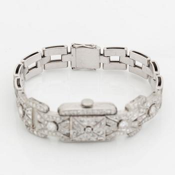 A bracelet/watch in platinum and 18K white gold set with old- and eight-cut diamonds.