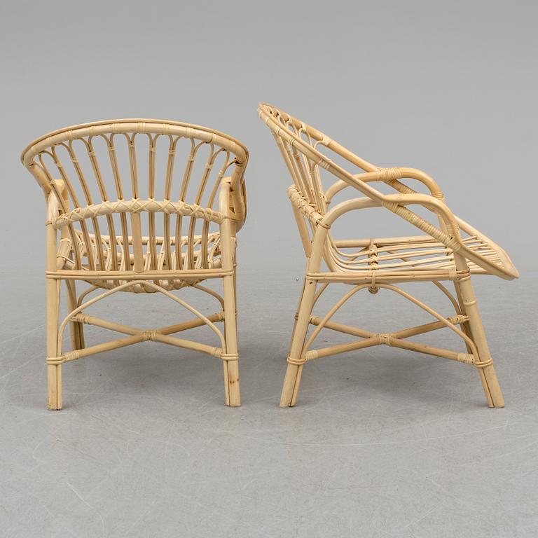 A pair of late 20th century rattan easy chairs.