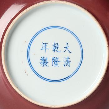 A copper-red glazed dish, Qing dynasty with Qianlong mark and of the period (1736-95).