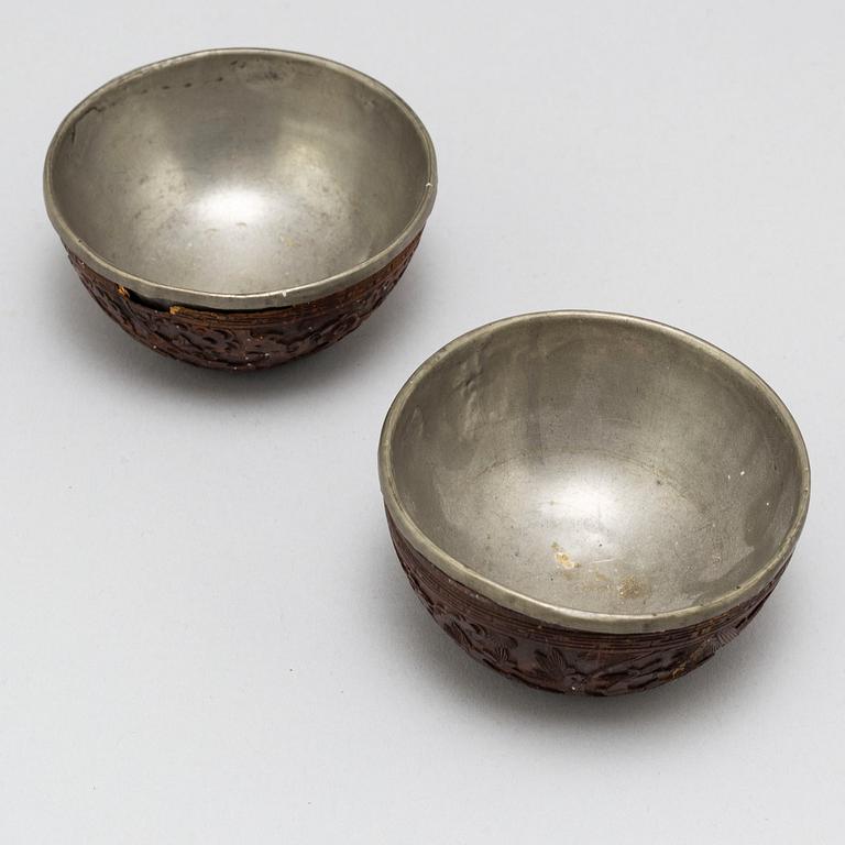 A pair of wooden bowls with pewter inlays, Qing dynasty, late 19th/early 20th century.