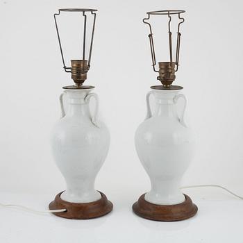A pair of white porcelain table lamps / urns, Europe 20th century.
