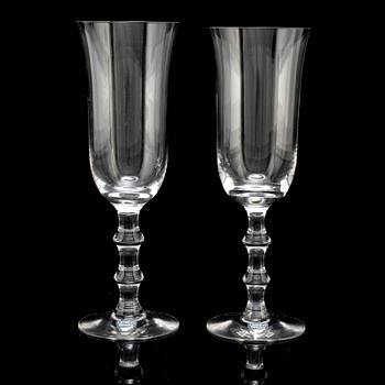 A set of twelve champagne glasses by Simon Gate.